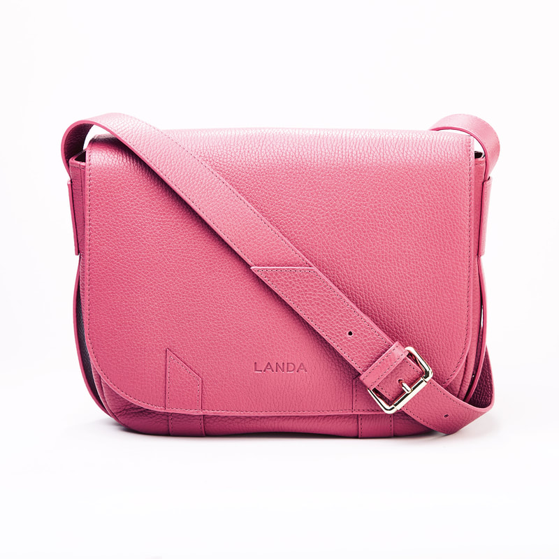 High quality product photography of a pink leather woman handbag shoot in studio